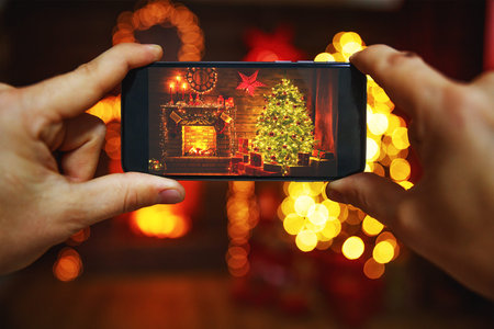 photo Christmas interior with a Christmas tree and  fireplace made on a smartphone