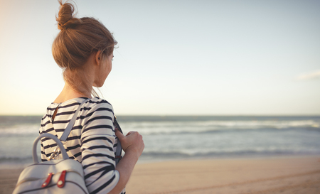 happy young woman enjoying freedom with open hands on sea
の写真素材