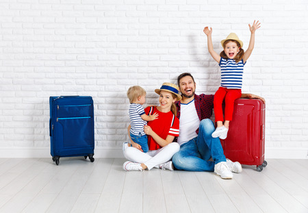 concept travel and tourism. happy family with suitcases near empty wallの写真素材