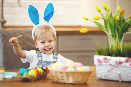 Happy easter! family mother and children paint eggs for the holiday