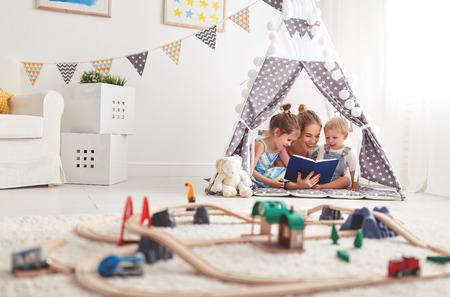 family mother reading to children book in tent in playroom at home
の写真素材