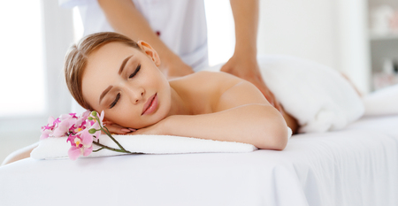 a beautiful girl enjoys massage and spa treatmentsの写真素材