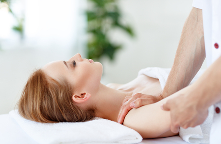 A beautiful girl enjoys massage and spa treatmentsの写真素材