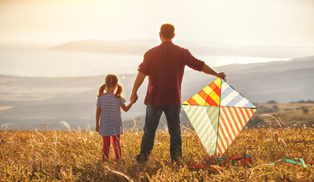 happy family father and child daughter launch a kite on meadowの写真素材