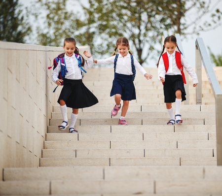 Happy children girls girlfriend schoolgirl student elementary schoolの写真素材