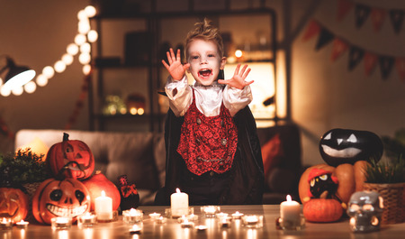 happy child  boy in costumes of vampire in a dark house in   holiday Halloweenの写真素材