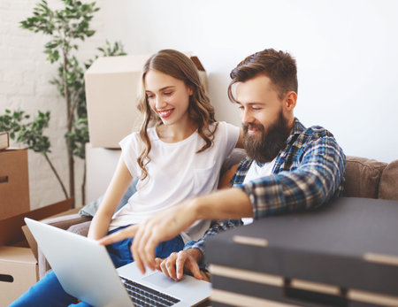 a happy young married couple moves to new apartment