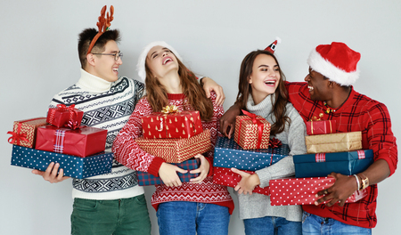 company of happy friends with Christmas gifts at the empty wall
の写真素材