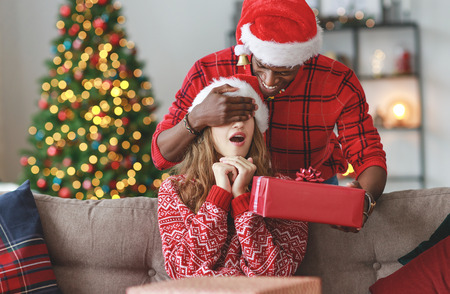 happy young couple opening presents on Christmas morning
の写真素材