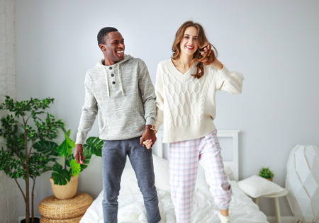 happy couple in love on a winter morning in bedの写真素材