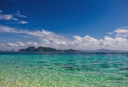 the beach, sea shore with sand and blue waterの写真素材