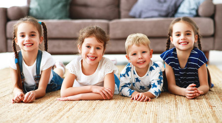 Happy kids friends brother and sister at home