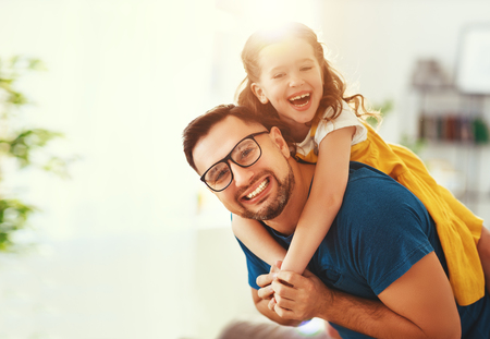 Father's day. Happy family daughter hugs his dad  on holidayの写真素材