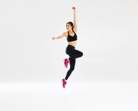 happy young woman doing fitness sports on white background