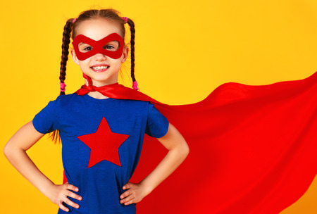 The concept of child superhero costume on yellow backgroundの写真素材