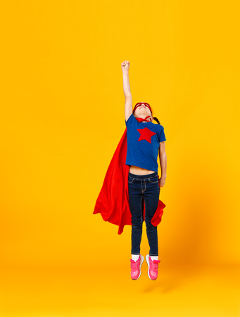 The concept of child superhero costume on yellow backgroundの写真素材