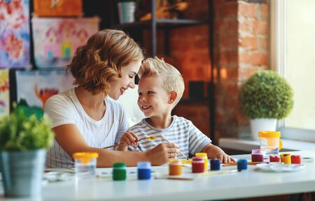 mother and child son  painting draws are engaged in creativity in kindergartenの写真素材