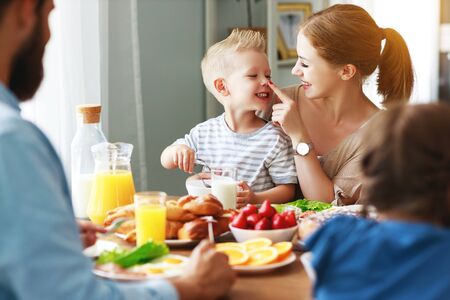 Family mother father and children have Breakfast in the kitchen in morningの写真素材