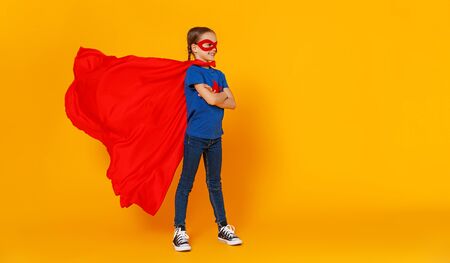 the concept of child superhero costume on yellow backgroundの写真素材