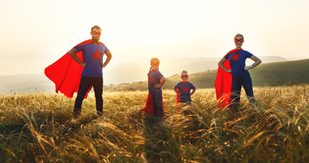 concept of super family, family of superheroes at sunset in nature