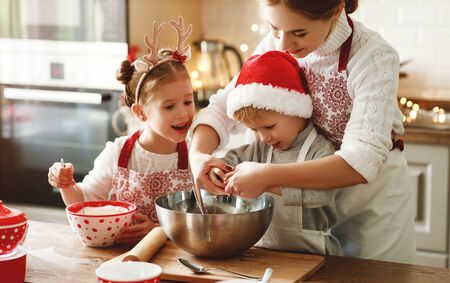 happy funny family mother and children  bake christmas cookiesの写真素材