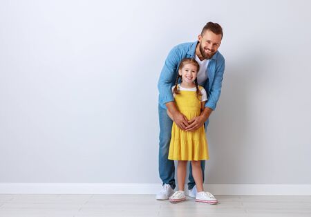 concept of the family. the father and child to a daughter near an empty wall
の写真素材