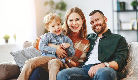 happy family mother father and kid son at home on the couch 