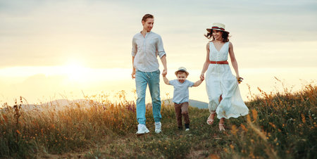 Happy family father of mother and child son  on nature at sunset
