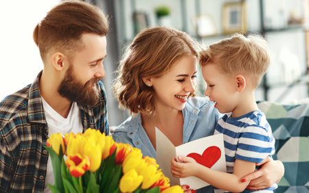happy mother's day! father and child son congratulate mother on holiday and give flowers