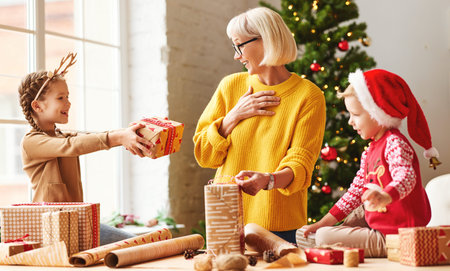 Surprised grandmother getting wrapped present from cute girl while standing in cozy room with...