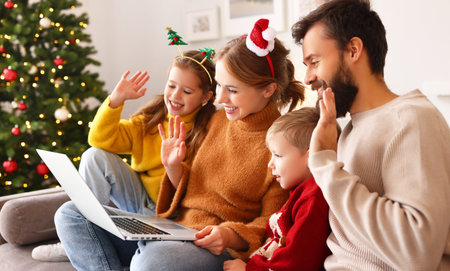happy family cheerful parents and joyful children make a video call to relatives on holiday near the...