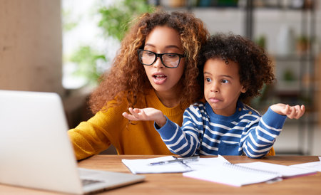 Afro american family, mother and child boy looking at laptop screen with surprised face expression...