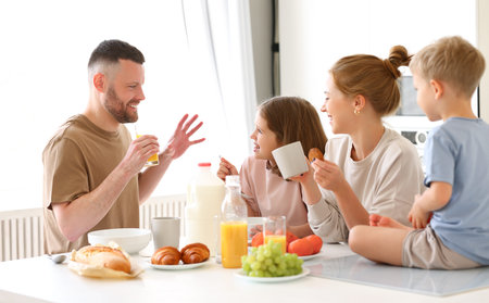 Family morning at home. Happy father, mother and two kids brother and sister enjoying time together...