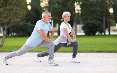 Energize your morning. Full length of active happy elderly family couple in sportswear working out...