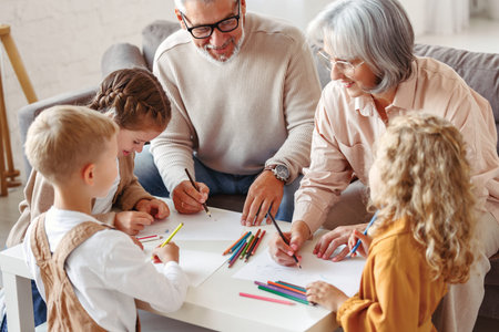 Smiling senior couple grandparents spending time with grandchildren at home on weekend