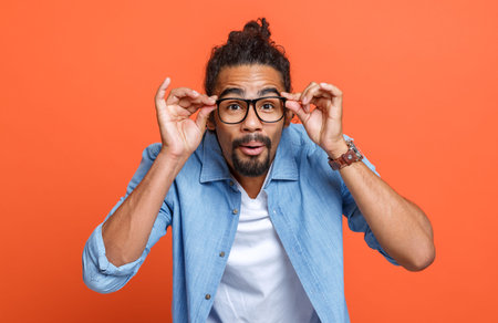 Bad eyesight. Young african american man wearing glasses squinting because of vision troubles