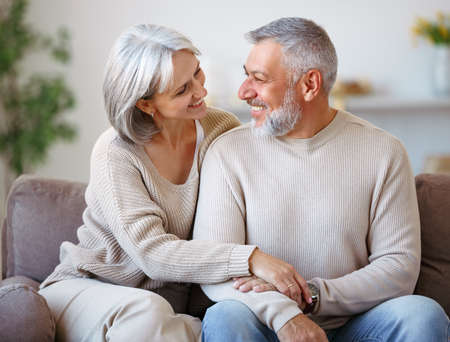 Beautiful smiling senior family couple husband and wife looking at camera with loveの写真素材