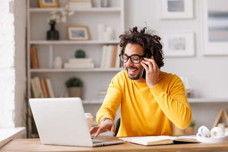 Emotional African American businessman making phone callの写真素材