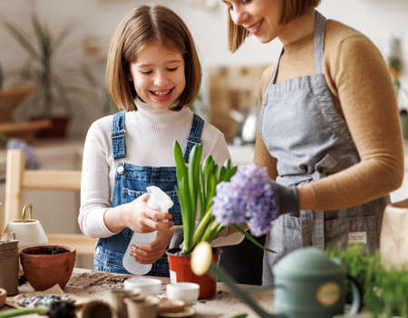 Mom and kid doing home gardening togetherの写真素材