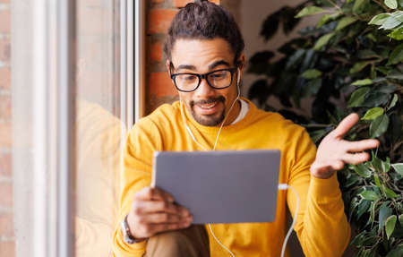 Ethnic male making video callの写真素材