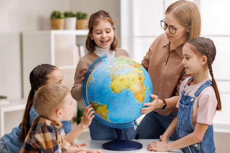 Teacher and kids during geography lesson at schoolの写真素材