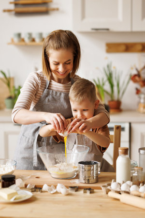 Happy woman and son cooking together in kitchenの写真素材