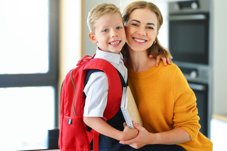 Mother preparing son for school studiesの写真素材