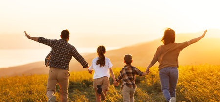 Happy family: mother, father, children son and daughter on sunsetの写真素材