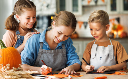 Young family mother and children preparing decorations for Halloweenの写真素材