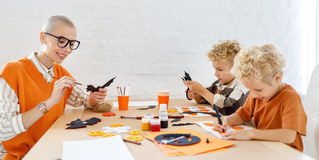 Young family mother and children preparing decorations for Halloweenの写真素材