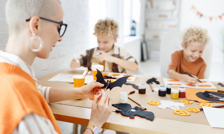 Young family mother and children preparing decorations for Halloweenの写真素材