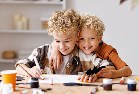Cute children boys making Halloween home decorationsの写真素材