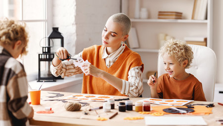 Young family mother and children preparing decorations for Halloweenの写真素材