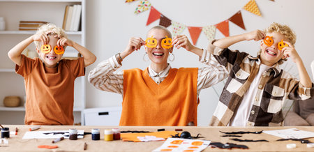 Young family mother and children preparing decorations for Halloweenの写真素材